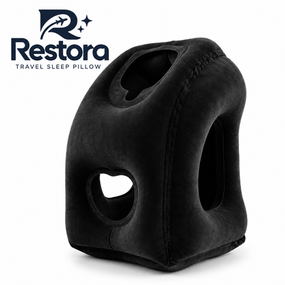 Black Restora travel sleep pillow, an inflatable forward-rest pillow with a face opening and side arm openings
